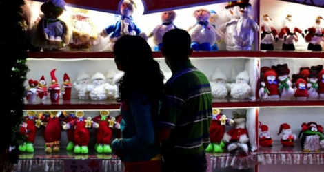 Des passants regardent des décorations de Noël dans une boutique à Tlalpujahua, dans l'Etat du Michoacan, le 16 décembre 2016 au Mexique.Des passants regardent des décorations de Noël dans une boutique à Tlalpujahua, dans l'Etat du Michoacan, le 16 décembre 2016 au Mexique.