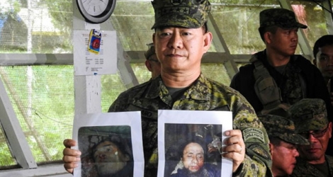 Le général Eduardo Ano, chef des militaires philippins montrent les photos des leaders islamistes Isnilon Hapilon (d) et Omarkhayam Maute (g) tués à Marawi, le 16 octobre 2017 