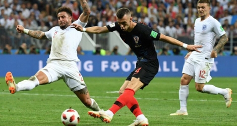 Le Croate Ivan Perisic frappe au but devant les Anglais Kyle Walker (g) et Kieran Trippier, en demi-finale du Mondial, le 11 juillet 2018 à Moscou 