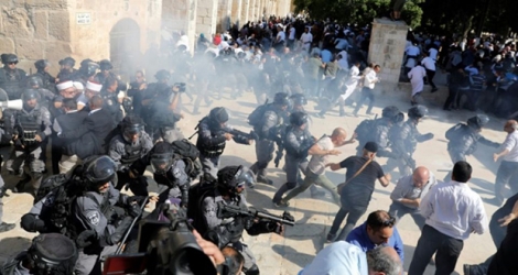 Les forces de sécurité israéliennes lancent des grenades assourdissantes sur les fidèles palestiniens sur l'esplanade des Mosquées à Jérusalem le 11 août 2019.
