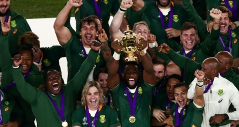 Le capitaine de l'Afrique du Sud, Siya Kolisi (c), brandit la Coupe du monde de rugby, à Yokohama, le 2 novembre 2019.
