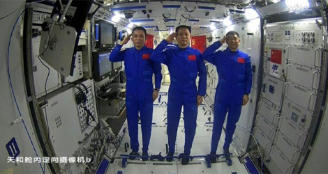 Les astronautes chinois Tang Hongbo (G), Nie Haisheng (C) et Liu Boming (D) saluant depuis la station spatiale chinoise le 23 juin 2021.