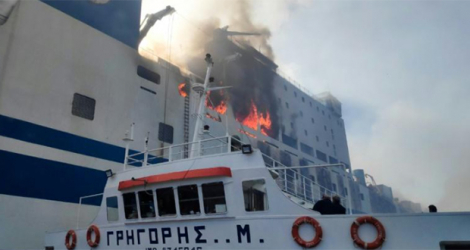 Un bateau des pompiers grecs s'approche du ferry italien Euroferry Olympia, n feu au large de l'île grec de Corfou, le 18 février 2022.